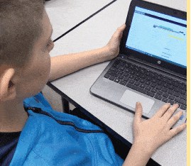 Greenville Student using laptop